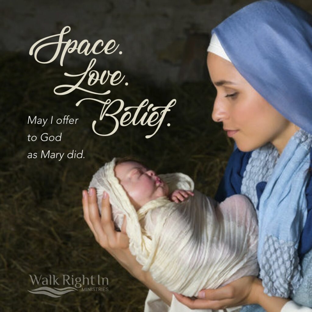 Mary holding and looking with love on baby Jesus